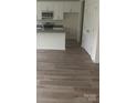 Modern kitchen featuring stainless steel appliances, an island, and hardwood style flooring at 631 S Elm St, Statesville, NC 28677