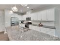 Modern kitchen with granite countertops and stainless steel appliances at 6842 Berewick Commons Pkwy, Charlotte, NC 28278