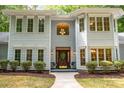 Inviting front entrance with a stained wood door and windowed sidelights, plus cozy seating at 6868 St Peters Ln, Matthews, NC 28105