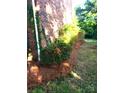 Well manicured yard with landscaping surrounding brick building at 8835 Hunter Ridge Dr, Charlotte, NC 28226