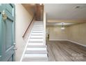 Welcoming foyer with staircase, new floors, and open access to the living area creating a seamless flow at 8835 Hunter Ridge Dr, Charlotte, NC 28226
