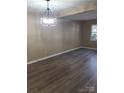 Bright living room with wood-look floors and modern lighting at 8835 Hunter Ridge Dr, Charlotte, NC 28226