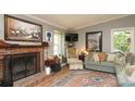 Inviting living room features a brick fireplace, ample seating, and a large picture window at 8903 New Town Rd, Waxhaw, NC 28173