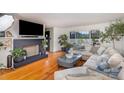 Bright living room featuring hardwood floors, a fireplace, and a comfortable sectional sofa at 910 E Center Ave, Mooresville, NC 28115