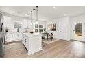 Modern kitchen with stainless steel appliances, white cabinets, and a central island at 9423 Weston Woods Ln, Charlotte, NC 28216