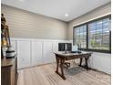 Bright office space featuring wainscoting, wide-plank wood floors, and ample natural light at 9620 Fire Bellied Ct, Lancaster, SC 29720