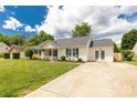 A beautiful ranch home is complemented by a driveway and lush green lawn at 9916 Meadowmead Ct # 17, Charlotte, NC 28273