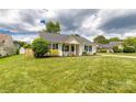 Well-maintained front yard showcasing a cozy home with green shutters and a classic design at 9916 Meadowmead Ct # 17, Charlotte, NC 28273