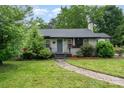 Charming single-story home with brick facade, landscaped yard, and inviting walkway under a bright sky at 1005 Home Trl, Gastonia, NC 28052