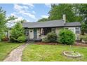Charming single-story home features lush landscaping, brick accents, and inviting walkway at 1005 Home Trl, Gastonia, NC 28052