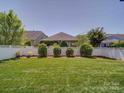 Spacious backyard featuring well-maintained lawn with a white picket fence at 1020 Equipoise Dr, Indian Trail, NC 28079