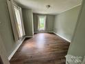 Bedroom with two windows providing ample natural light and wood flooring at 1025 Martin Luther King Jr Dr, Albemarle, NC 28001