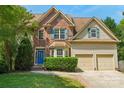 Charming two-story home with a brick facade, well-maintained lawn, and a two-car garage in a landscaped neighborhood at 10316 Willingham Rd, Huntersville, NC 28078