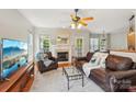 Inviting living room featuring hardwood floors, a cozy fireplace, and ample natural light from large windows at 10316 Willingham Rd, Huntersville, NC 28078