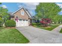 Beautiful home showcasing a stone and siding facade, two-car garage, and well-maintained landscaping at 11008 Round Rock Rd, Charlotte, NC 28277