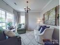 Cozy living room with comfortable seating, soft lighting, and elegant decor with neutral color palette at 1103 Cooper Ln, Indian Trail, NC 28079