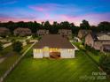 Expansive backyard featuring a well-maintained lawn, a wooden deck, and a fence at 1128 Rosecliff Dr, Marvin, NC 28173