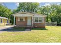 Exterior of a small single-story brick house with a covered porch and a green lawn at 1214 Short St, Salisbury, NC 28144