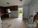 An outdated kitchen provides outside access to a backyard porch via a white door with glass window at 1224 Bailey St, Albemarle, NC 28001