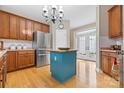 Bright kitchen featuring stainless steel appliances, a center island, and access to the outdoors through French doors at 1244 Saint Johns Ave, Matthews, NC 28104