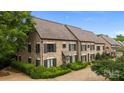 An elevated view of a stone townhome showcasing its architectural details and landscaped surroundings at 1550 High St, Charlotte, NC 28211