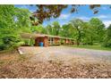Classic brick home with a convenient carport and a spacious front yard at 1713 Wildwood Dr, Albemarle, NC 28001