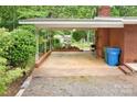 View of the home's covered patio showing a brick floor, brick surround, and ample room for outdoor furniture at 1713 Wildwood Dr, Albemarle, NC 28001