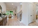 Inviting entryway featuring modern stairs and a glimpse into the stylish living room, creating a warm welcome at 1807 Arnold Dr, Charlotte, NC 28205
