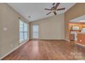Well lit living room with ceiling fan, and view into the kitchen, adjacent to the dining area at 2008 Taras Trace Dr, Statesville, NC 28625