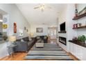 Cozy living room featuring a fireplace, hardwood floors, and stylish decor at 206 Summey Barker Dr, Dallas, NC 28034
