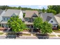 Aerial view of a well-maintained home with mature trees in a serene neighborhood setting with surrounding homes at 209 Helton Ln, Fort Mill, SC 29708