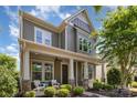 Beautiful two-story home with a covered front porch, decorative columns, and freshly manicured landscaping at 209 Helton Ln, Fort Mill, SC 29708