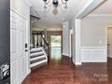 Inviting foyer showcasing hardwood floors, staircase, and open view to living areas at 2369 Baxter Se Pl, Concord, NC 28025