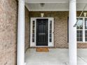 View of the front door with white columns and sidelights, showing the house number 2369 at 2369 Baxter Se Pl, Concord, NC 28025