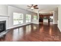 Bright and spacious living room features wood floors, fireplace, and large windows at 2369 Baxter Se Pl, Concord, NC 28025