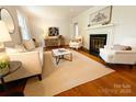 Bright living room features a fireplace, hardwood floors, and neutral-toned furnishings for a cozy ambiance at 3020 Hampton Ave, Charlotte, NC 28207