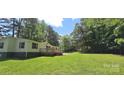 Single-story home with a large front yard and mature trees offering great curb appeal at 307 Aquarius Dr, Clover, SC 29710