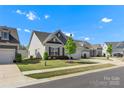 Attractive single-story home with a well-manicured front lawn and a convenient two-car garage at 329 Brambling Ct, Monroe, NC 28110