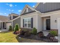 Close-up of a lovely home's front entrance with manicured landscaping and a well-kept lawn at 329 Brambling Ct, Monroe, NC 28110