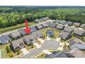 An aerial view showcases this house nestled in a neighborhood with lush green surroundings at 329 Brambling Ct, Wesley Chapel, NC 28110