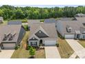 An aerial view showcases a well-maintained home with a manicured lawn in a desirable neighborhood at 329 Brambling Ct, Wesley Chapel, NC 28110