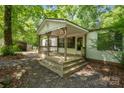 Inviting covered front porch with wooden support beams and stairs, offering a cozy outdoor space at 351 Fletcher Rd, Union Grove, NC 28689