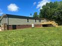 Spacious backyard featuring a wooden deck and mature trees at 353 Quail Pointe Dr, Salisbury, NC 28147