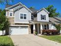 Attractive two-story home with stone and siding exterior, complemented by a spacious driveway at 413 Hunton Forest Dr, Concord, NC 28027
