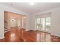 Spacious living room with hardwood floors, a large window and views of the entry and dining room at 4410 Laurel Twig Ct, Charlotte, NC 28215