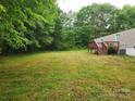 An expansive, private backyard provides ample space, a deck, and mature trees at 544 Bentley Rd, Shelby, NC 28152