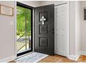Inviting home entryway with dark door and decorative welcome mat plus views of the outside at 613 W Pine St, Kershaw, SC 29067