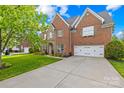 Beautiful brick home with a two-car garage and long driveway on a sunny day at 619 Vega Nw St, Concord, NC 28027
