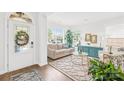 Bright and inviting living room with large windows, neutral decor, and hardwood floors at 619 Vega Nw St, Concord, NC 28027