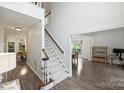 Spacious foyer with hardwood floors and a staircase leading to the second floor at 6723 Joliette Ln, Charlotte, NC 28277